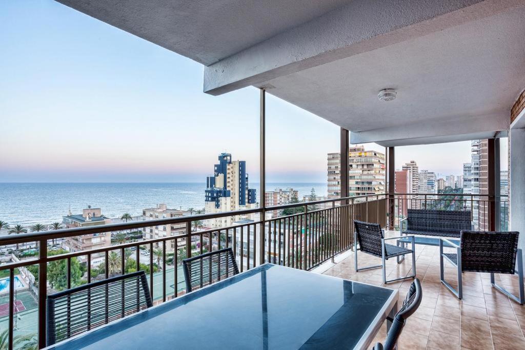 a balcony with a table and chairs and the ocean at GLP Dreams Torre Alazan in Alicante