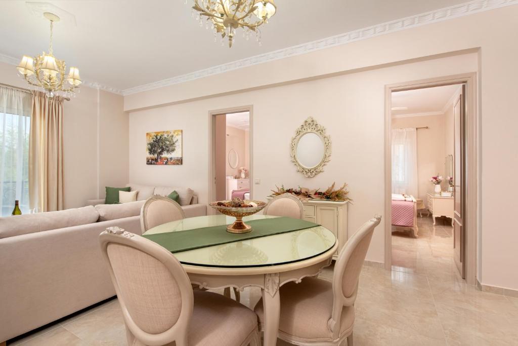 een woonkamer met een tafel en een bank bij Nostalgia Corfu Town Apartments in Corfu-stad