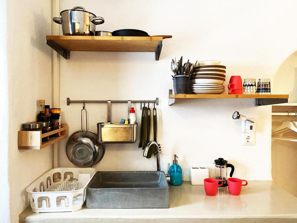 a kitchen counter with a sink and some shelves at Bougainvillea Friends & Family Studio - Old Town in Mýkonos City