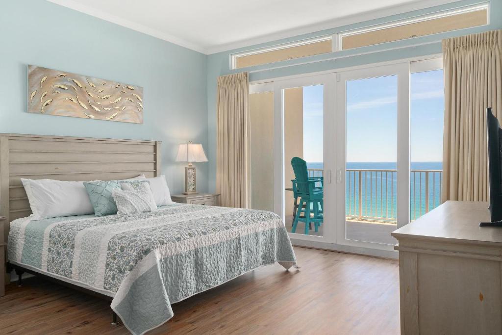 a bedroom with a bed and a view of the ocean at The Lookout Unit 2021 in Panama City Beach