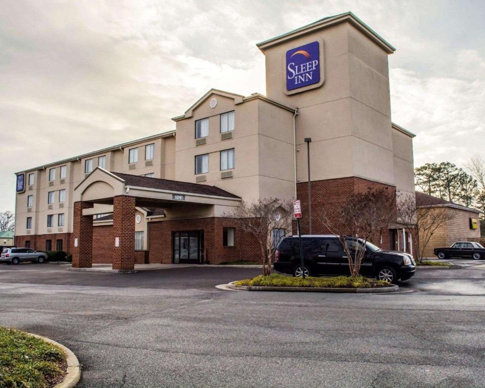 un hôtel avec une voiture garée devant lui dans l'établissement Sleep Inn Richmond North, à Richmond