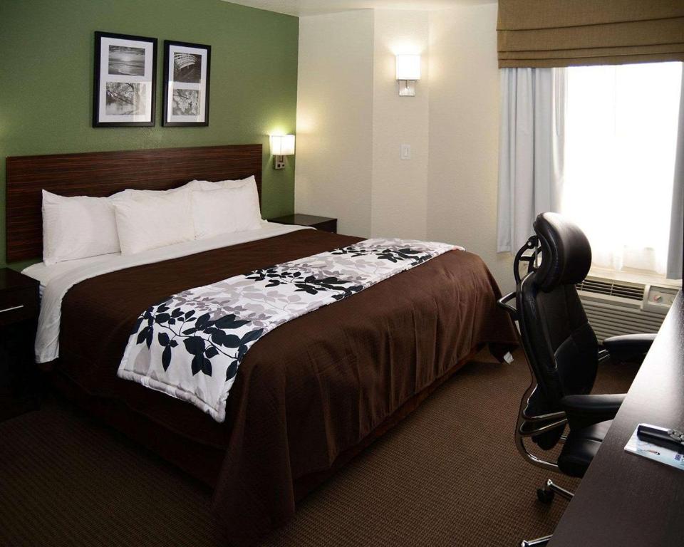 a hotel room with a bed and a chair at Sleep Inn Horn Lake-Southaven in Horn Lake