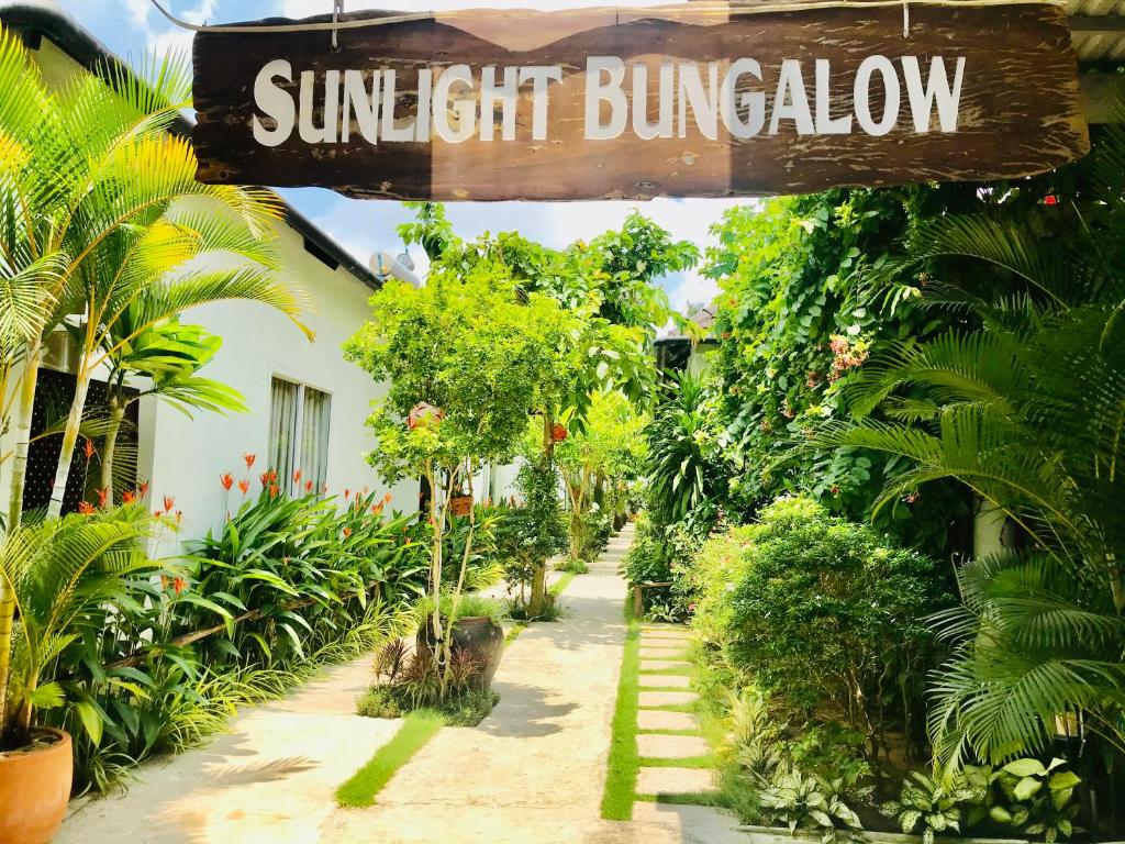 a sign for the sun light bunatown in a garden at Sunlight Bungalow in Phú Quốc