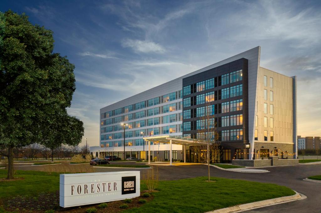 a large building with a sign in front of it at The Forester, a Hyatt Place Hotel in Lake Forest