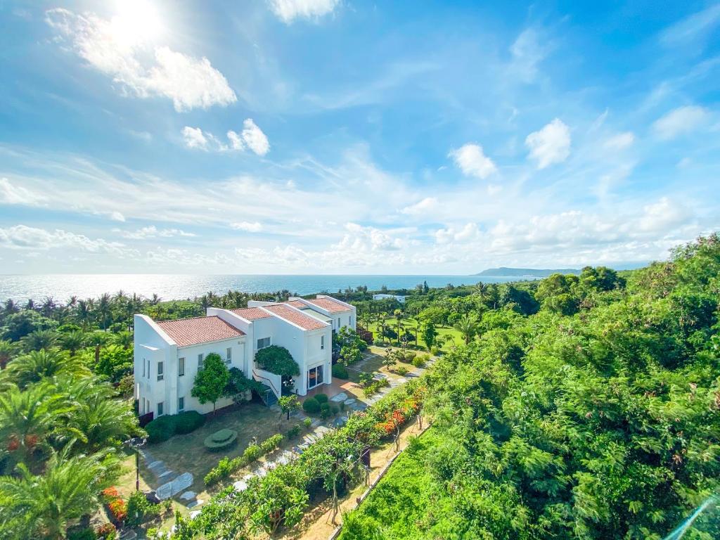an aerial view of a house on a hill with the ocean at Bay Forest Boutique B&amp;B in Hengchun South Gate