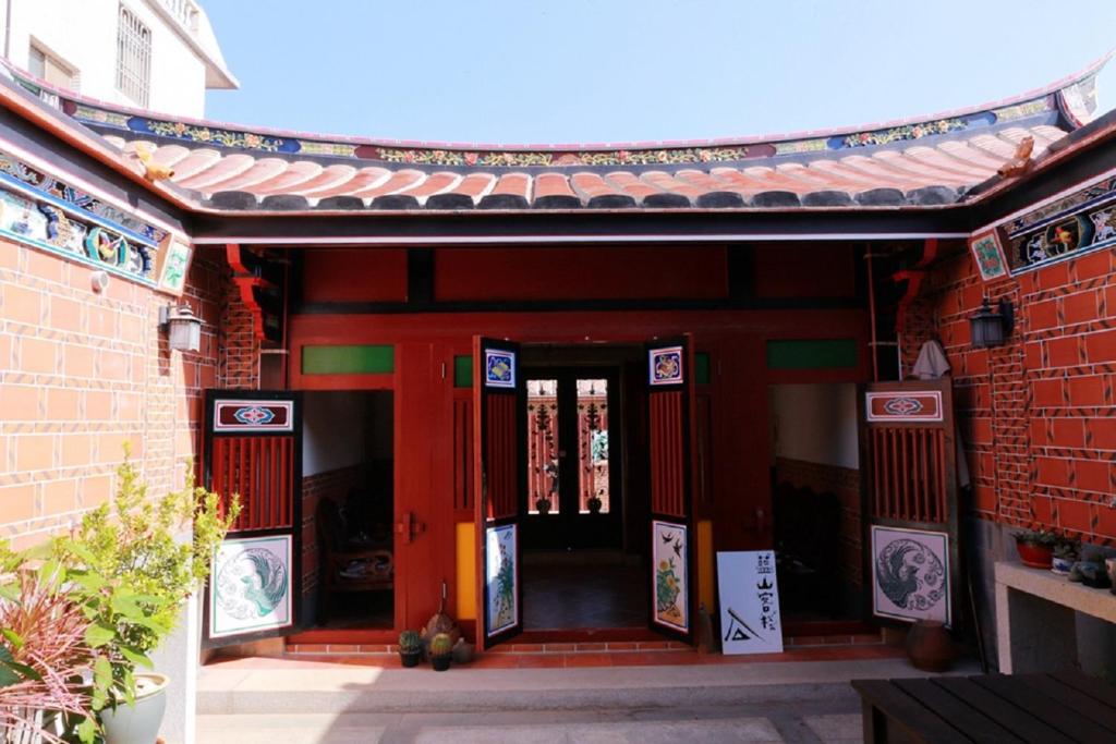 an entrance to a building with a red door at Blue Mountain Inn in Jinning