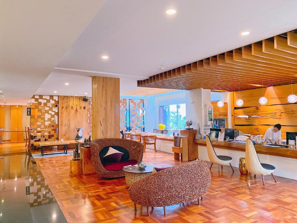 a lobby with chairs and tables and a counter at Bay Forest Boutique B&amp;B in Hengchun South Gate