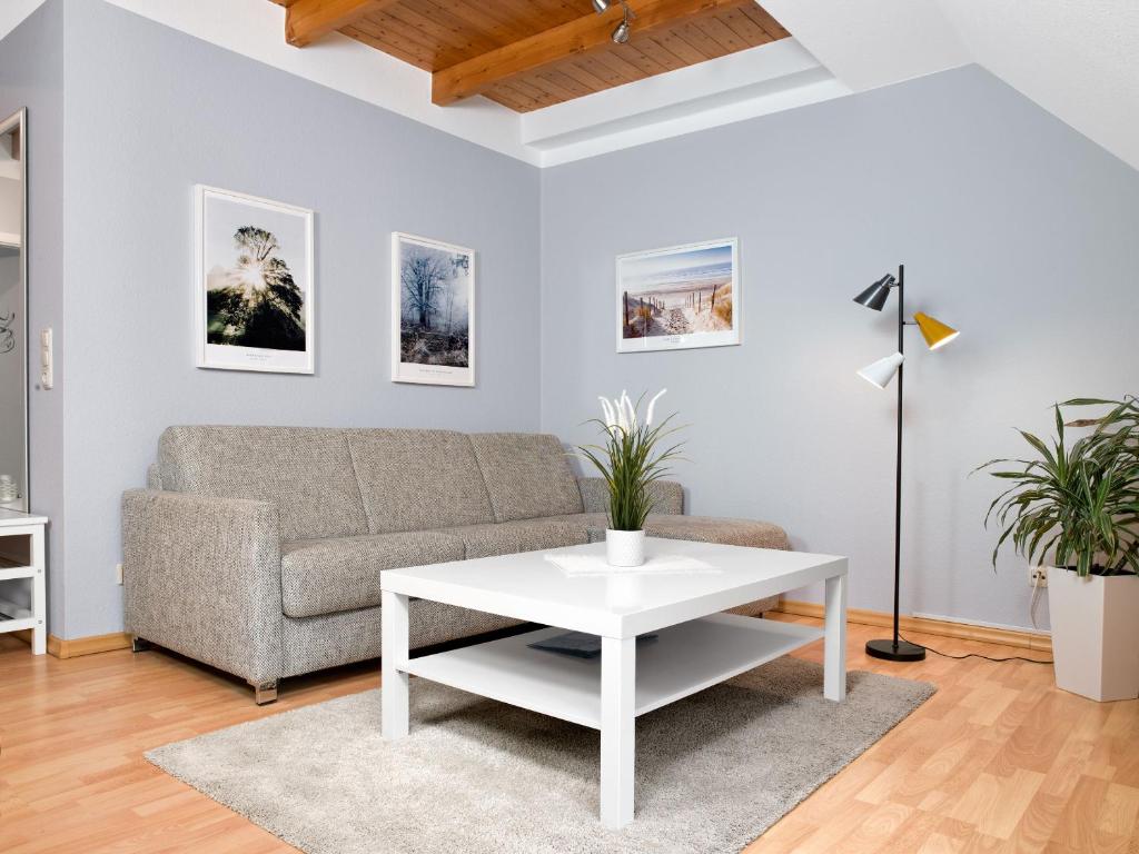 a living room with a couch and a table at Appartements Am Reiterhof Meerzeit in Timmendorf