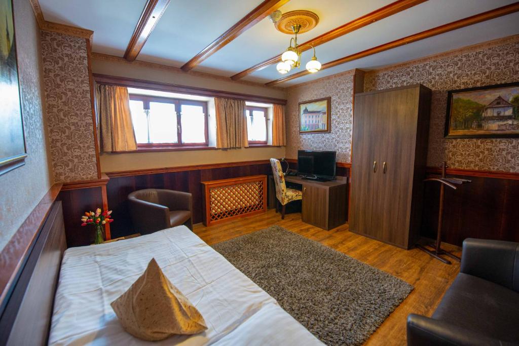 Postel nebo postele na pokoji v ubytování Hotel Kuria