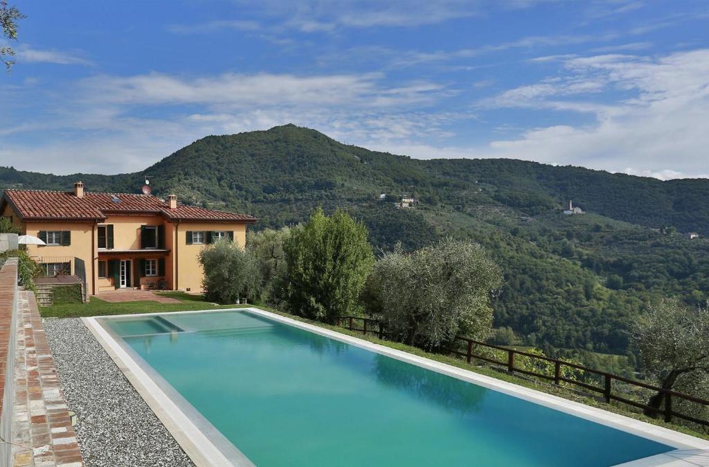 een zwembad voor een huis met een berg bij Santo Stefano 6 in Lucca