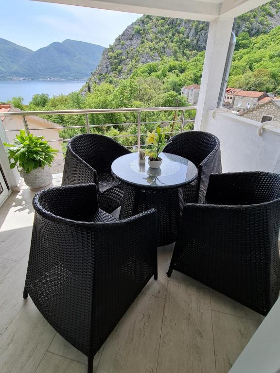 a patio with a table and chairs on a balcony at Lux apartmani Darija in Kotor