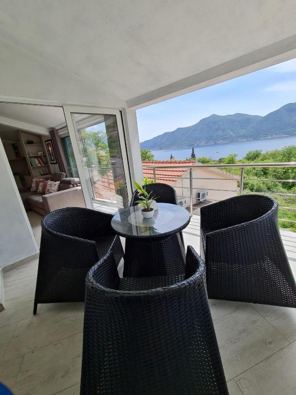 a patio with a table and chairs with a view at Lux apartmani Darija in Kotor