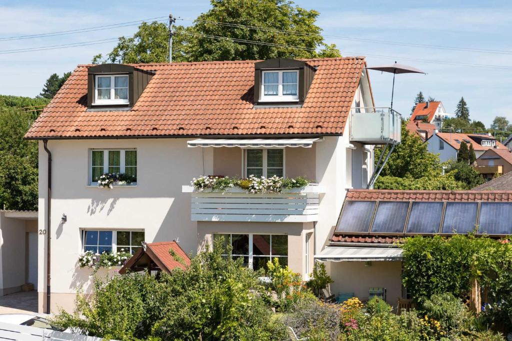 a white house with a red roof at Ferienwohnung Bodensee Fisch in Meersburg