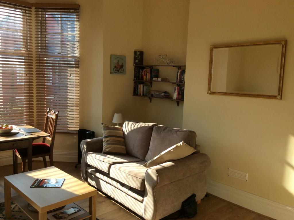 a living room with a couch and a table at One bedroom flat on a quiet road in Colwyn Bay