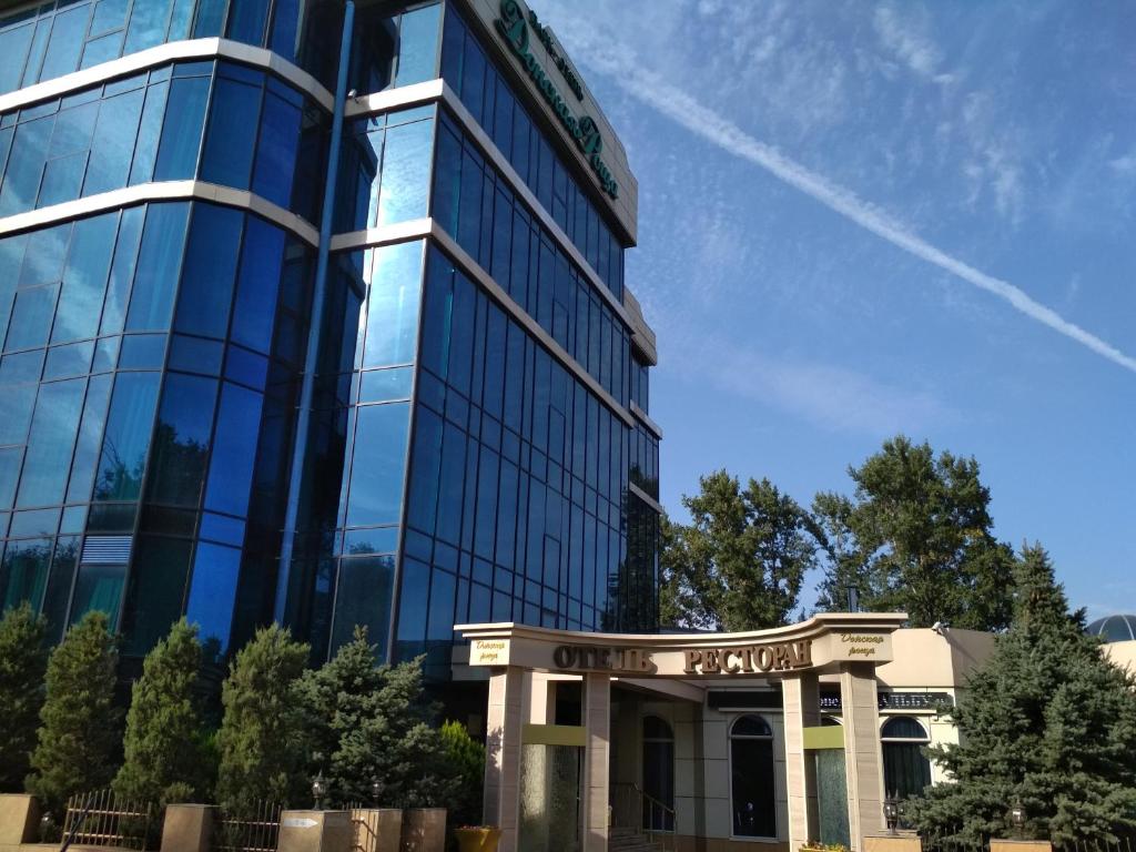 a tall glass building with a sign on it at Donskaya Roscha Park Hotel in Rostov on Don