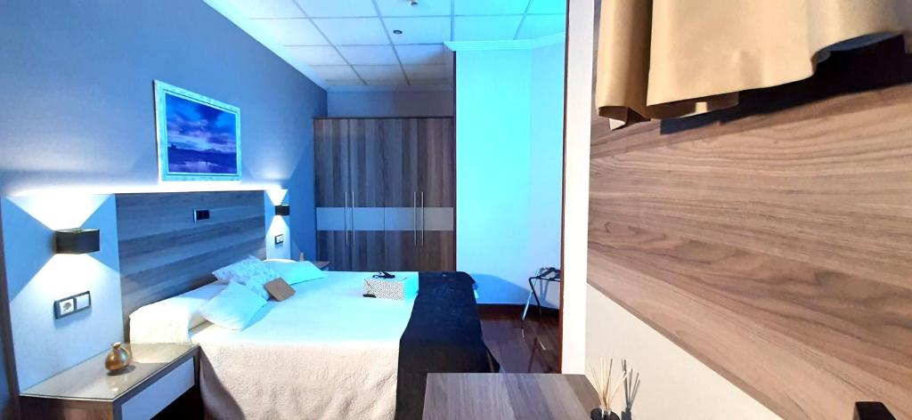 Postel nebo postele na pokoji v ubytování Hotel Nueva Plaza