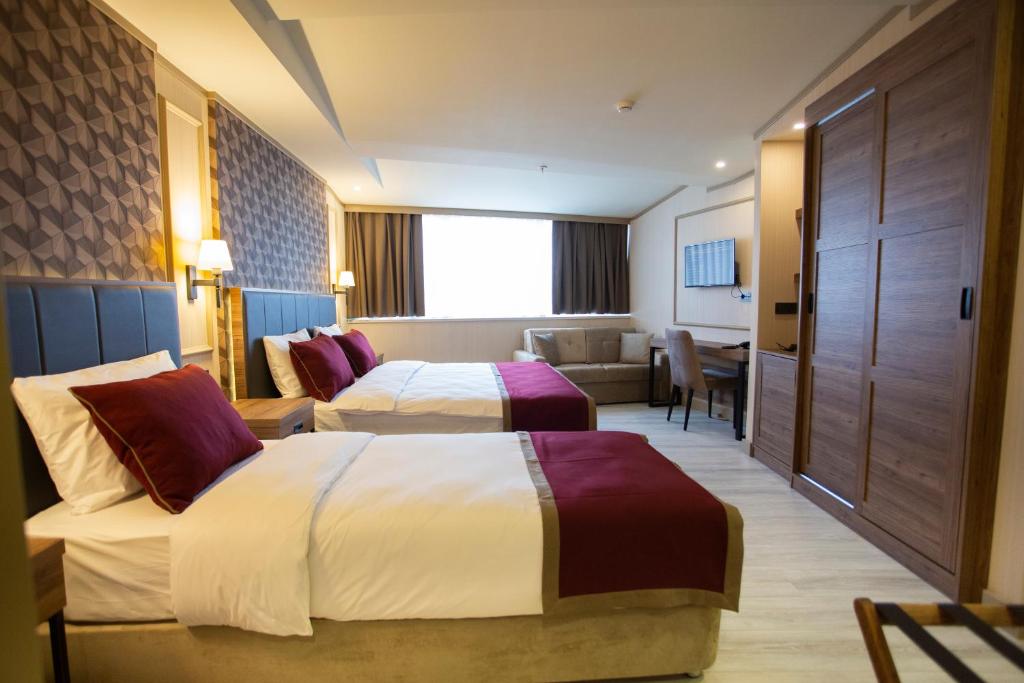 伊斯坦堡的住宿－Beşiktaş Serenity Hotel，酒店客房,设有两张床和一张沙发