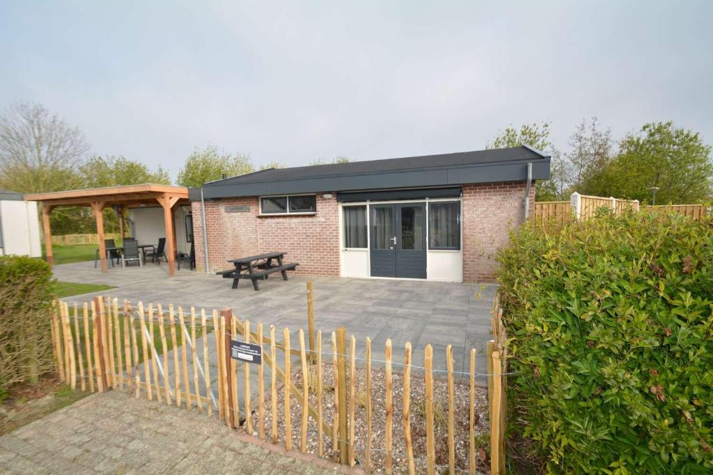 a house with a patio and a picnic table at Lamsoor in Serooskerke
