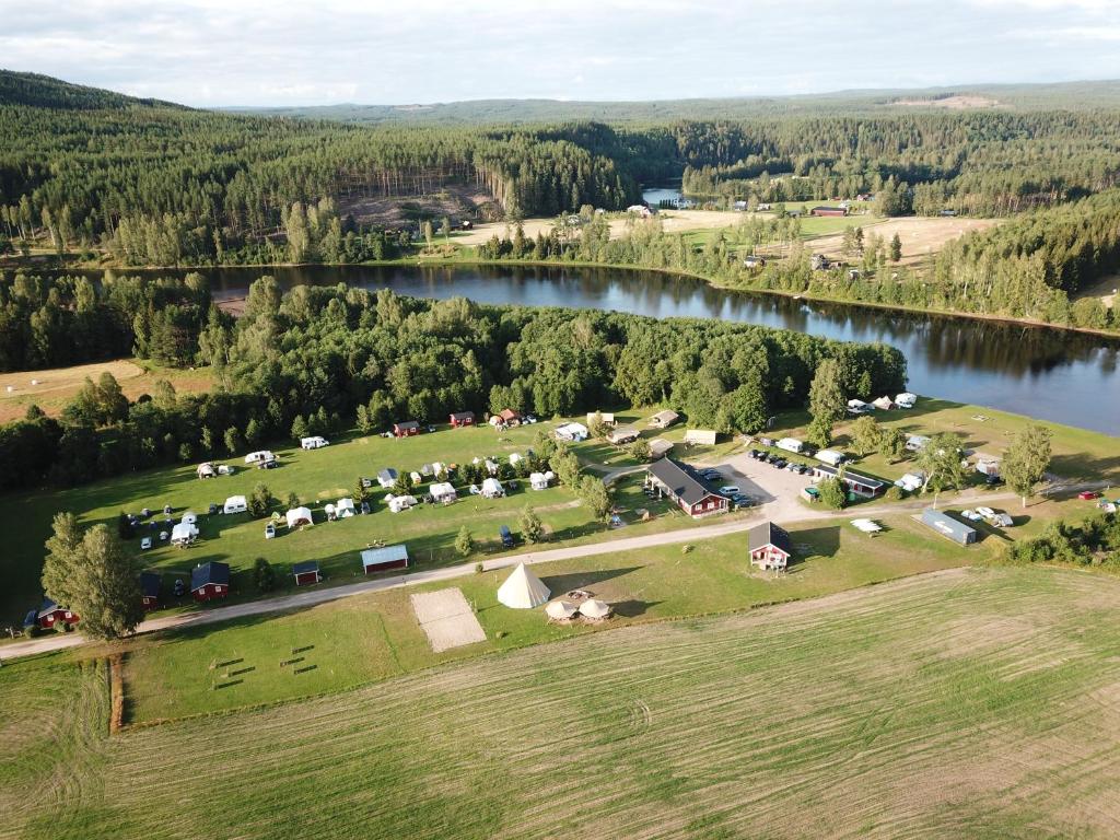 an aerial view of a farm next to a lake at Alevi Camping in Stöllet