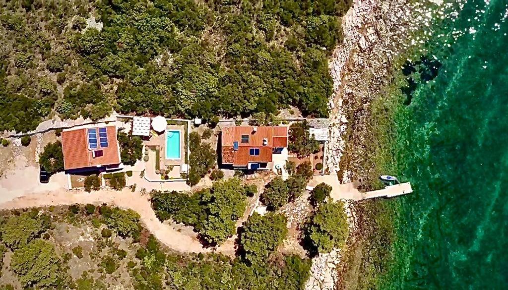 an aerial view of a house on an island next to the ocean at Robinson House Bosiljka in Dobropoljana