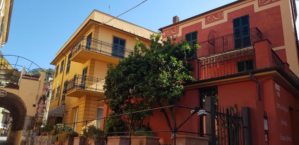 a row of colorful buildings on a street at Hotel Margherita in Monterosso al Mare