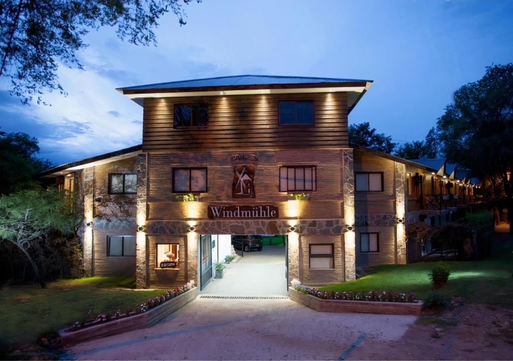a large house with lights on the front of it at Windmuhle Apart Hotel & Spa in Villa General Belgrano