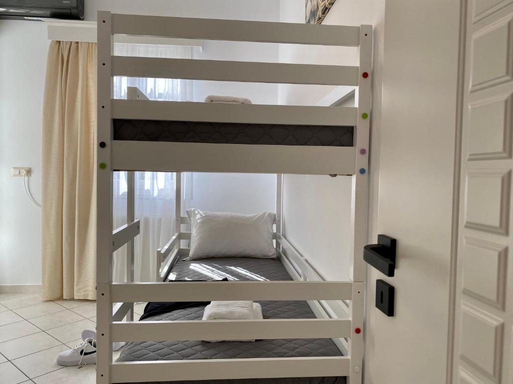 a bunk bed in a room with a bunk bed in a room at PORTA HOME modern and hospitable in Naxos Chora