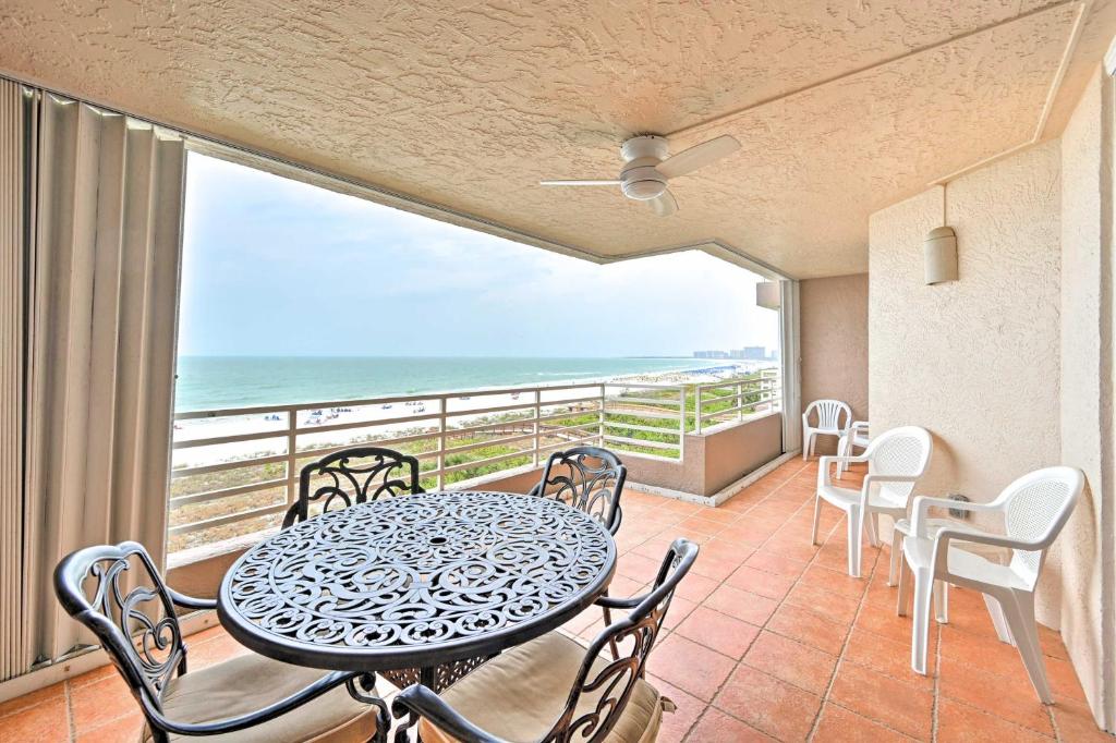 a balcony with a table and chairs and the ocean at Oceanfront Marco Island Escape with Beach Access! in Marco Island