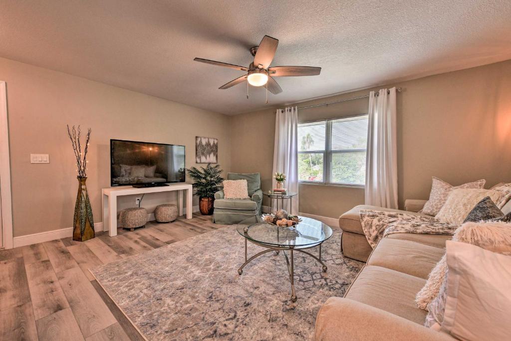 a living room with a couch and a ceiling fan at Cozy Sarasota Retreat - 3 Blocks to the Coast! in Sarasota