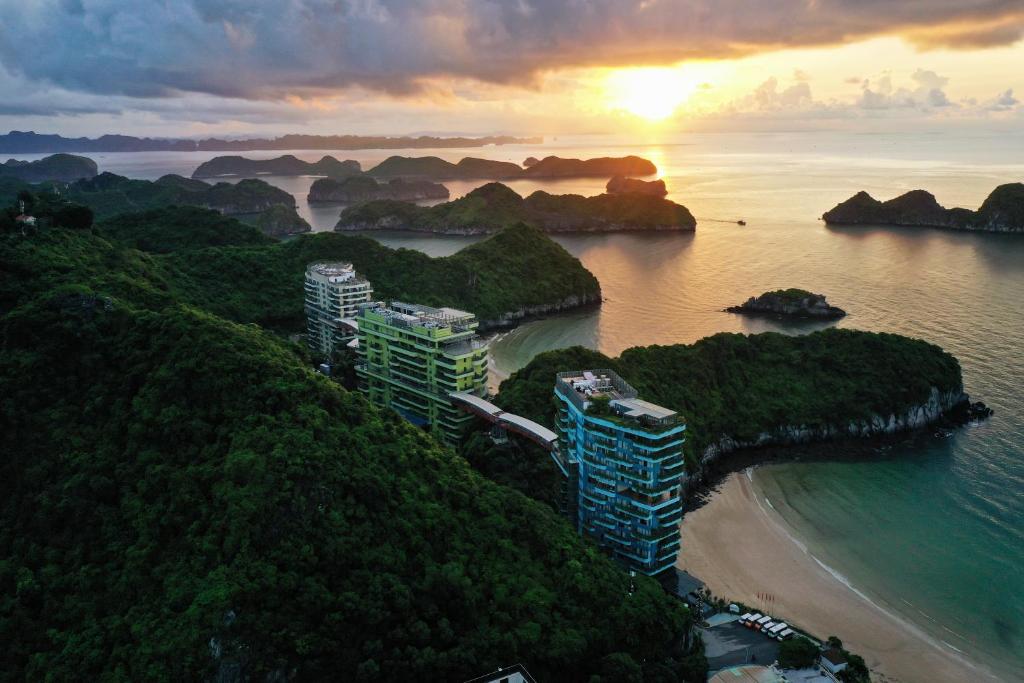 an aerial view of a beach with buildings on a hill at Flamingo Cat Ba Resort Apartment in Hai Phong