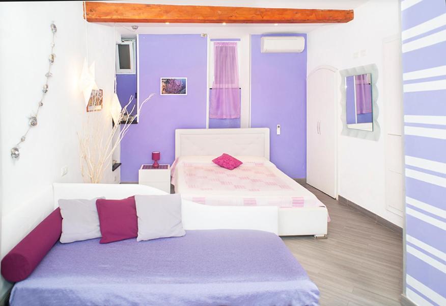 Postel nebo postele na pokoji v ubytování I Coralli rooms & apartments
