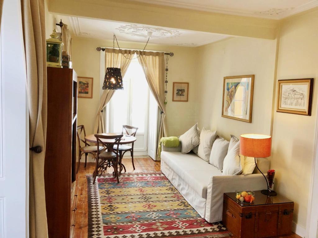 a living room with a couch and a table at Remodeled Historic Apartment in Bairro Alto in Lisbon