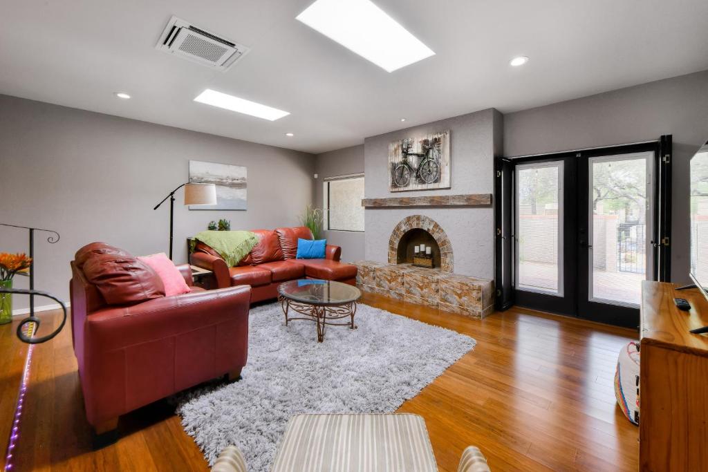 a living room with two couches and a fireplace at Colonia Verde in Tucson