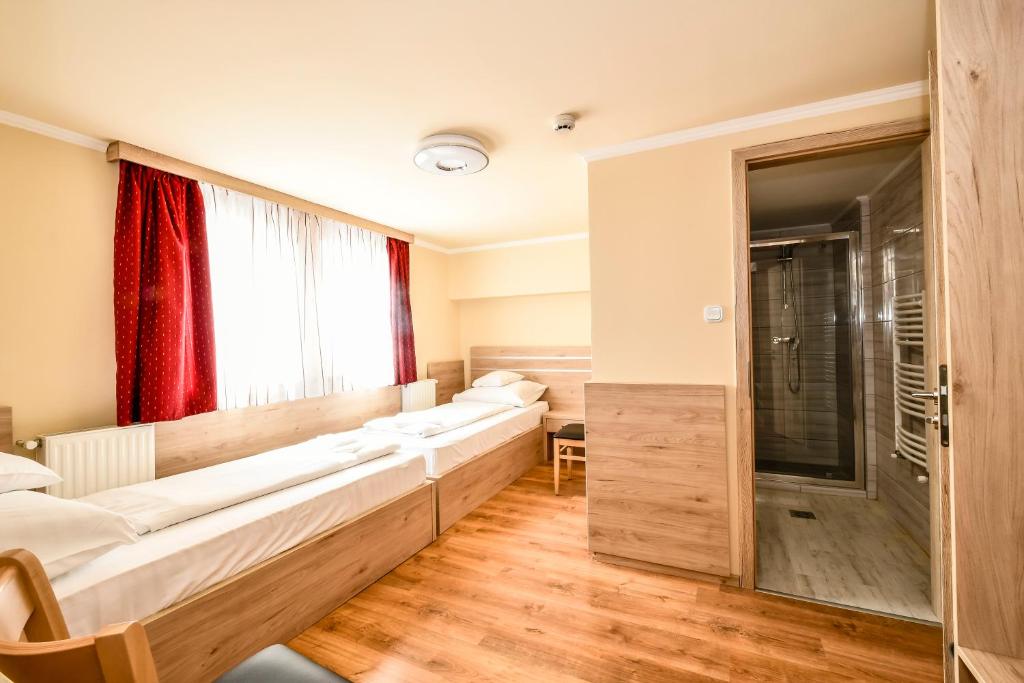 Postel nebo postele na pokoji v ubytování Hotel Rózsa Csárda