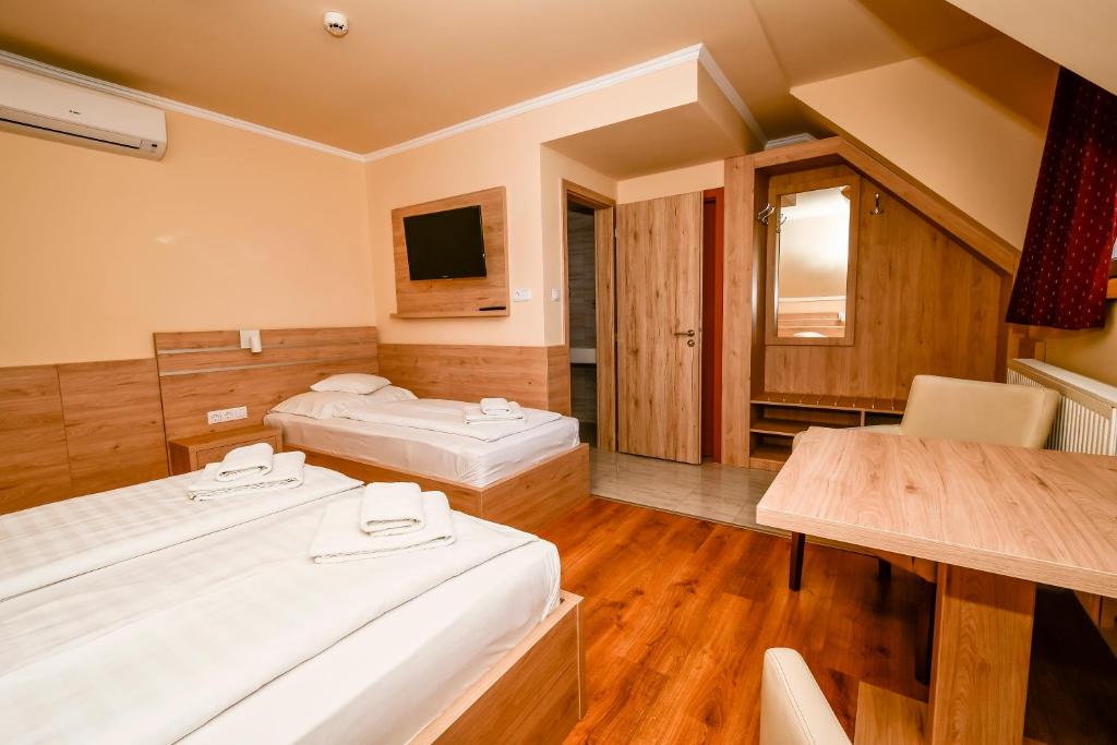 Postel nebo postele na pokoji v ubytování Hotel Rózsa Csárda