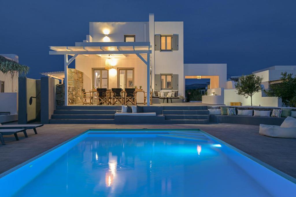 a villa with a swimming pool at night at Villa Tranquillity in Kastraki