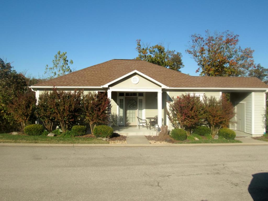 a white house with a brown roof at Two Bedroom Villa in the Heart of Branson! in Branson