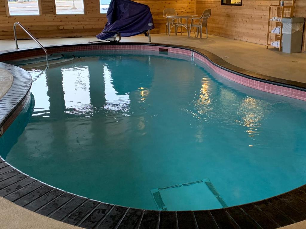 a swimming pool in a house with blue water at Days Inn by Wyndham Hinckley in Hinckley