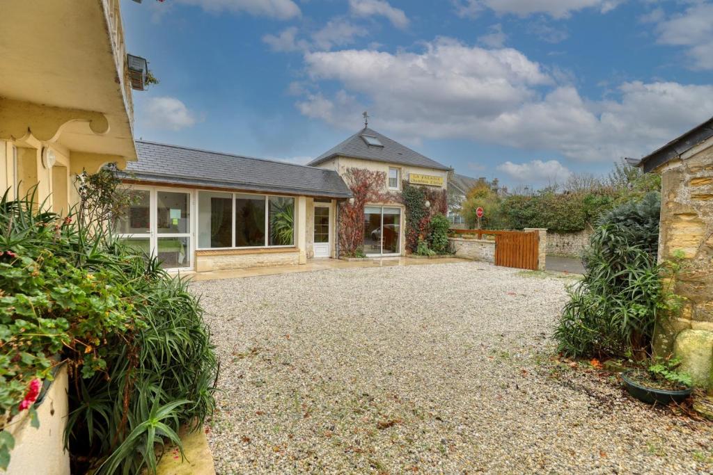 ein Haus mit Kieseinfahrt davor in der Unterkunft Maison de 5 chambres avec jardin clos et wifi a Commes a 6 km de la plage in Commes