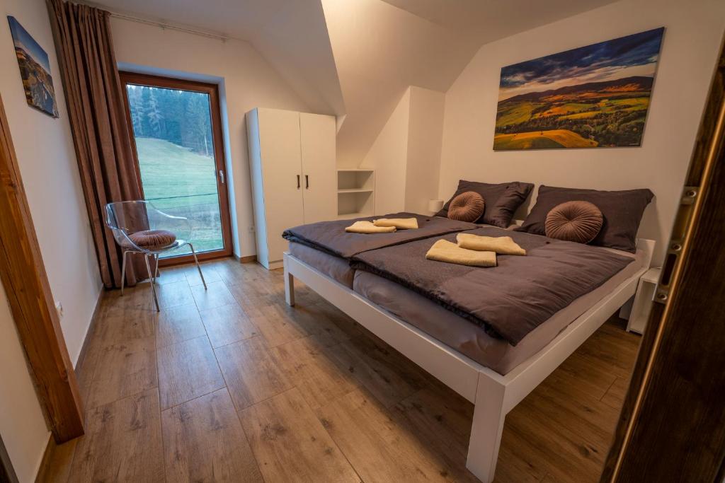 a bedroom with a large bed with two towels on it at Wellness Chalupa Horní Orlice in Králíky