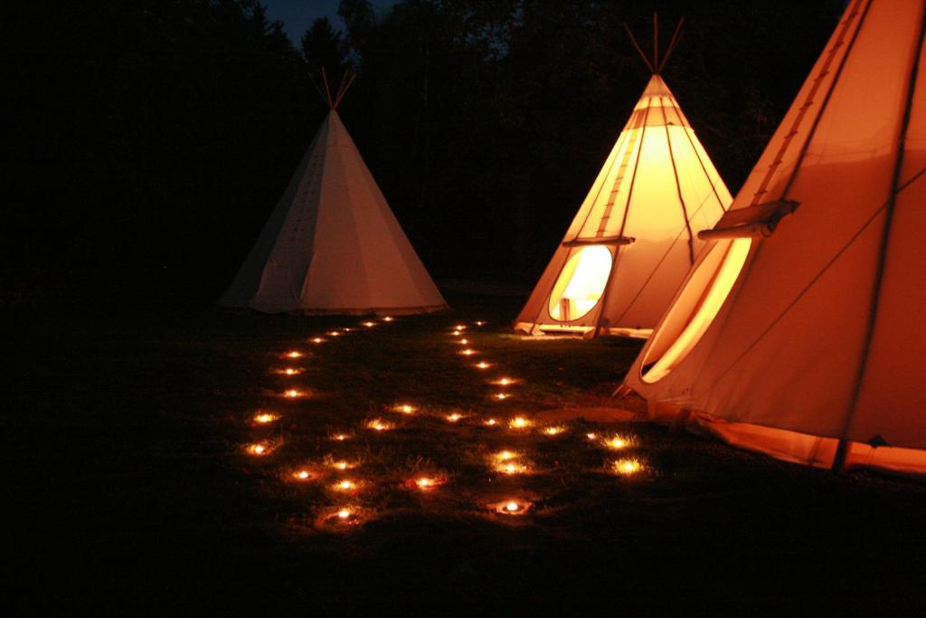 a couple of tents with lights in the dark at Domaine de Carnin in Beloeil