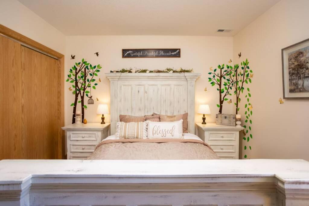a bedroom with a large bed with two night stands at Woodland Legacy-Escape to unwind in Mount Vernon