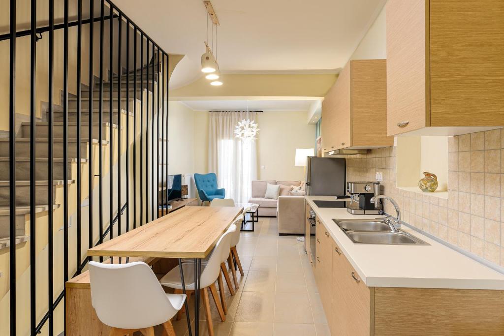 a kitchen with a table and a dining room at Stella Maris - Sivota Holiday Home in Sivota