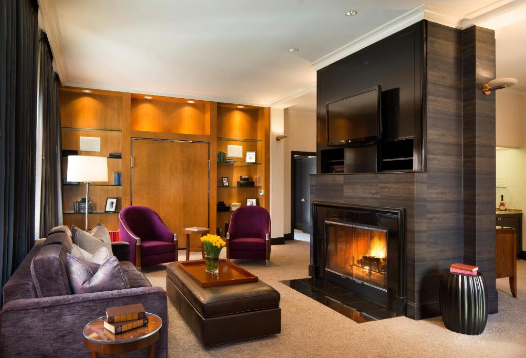 a living room with a couch and a fireplace at Hotel De Anza, a Destination by Hyatt Hotel in San Jose