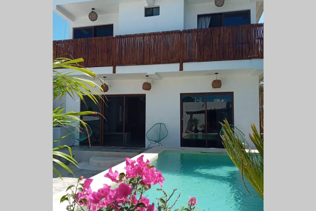 a villa with a swimming pool and a balcony at Casa Emma in Holbox Island