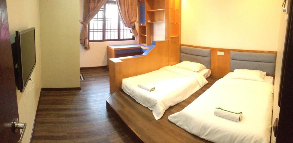 Postel nebo postele na pokoji v ubytování Homestay Muar