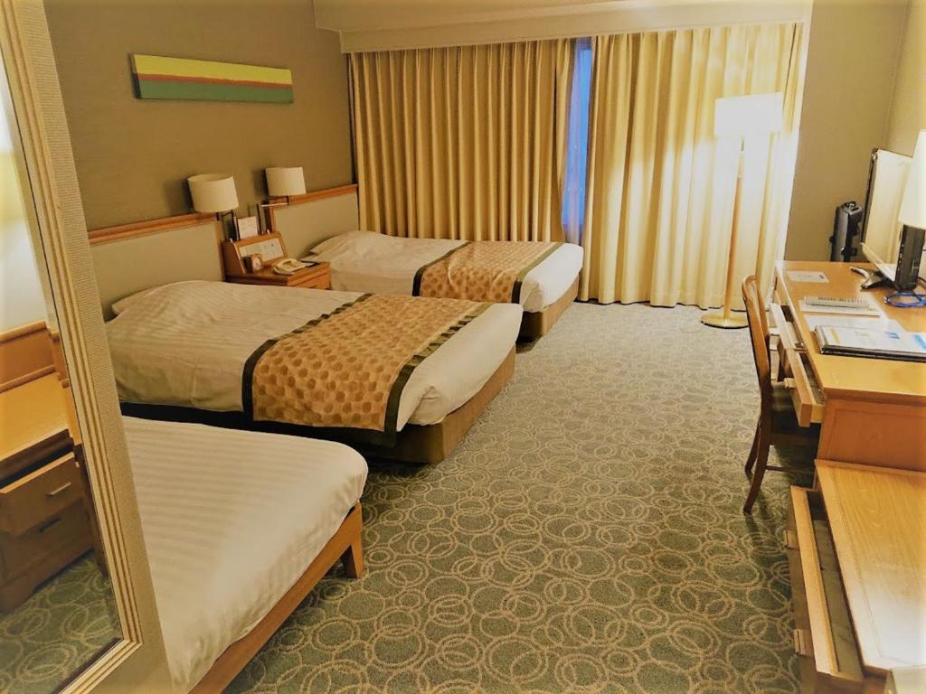 Postel nebo postele na pokoji v ubytování JR Hotel Clement Tokushima