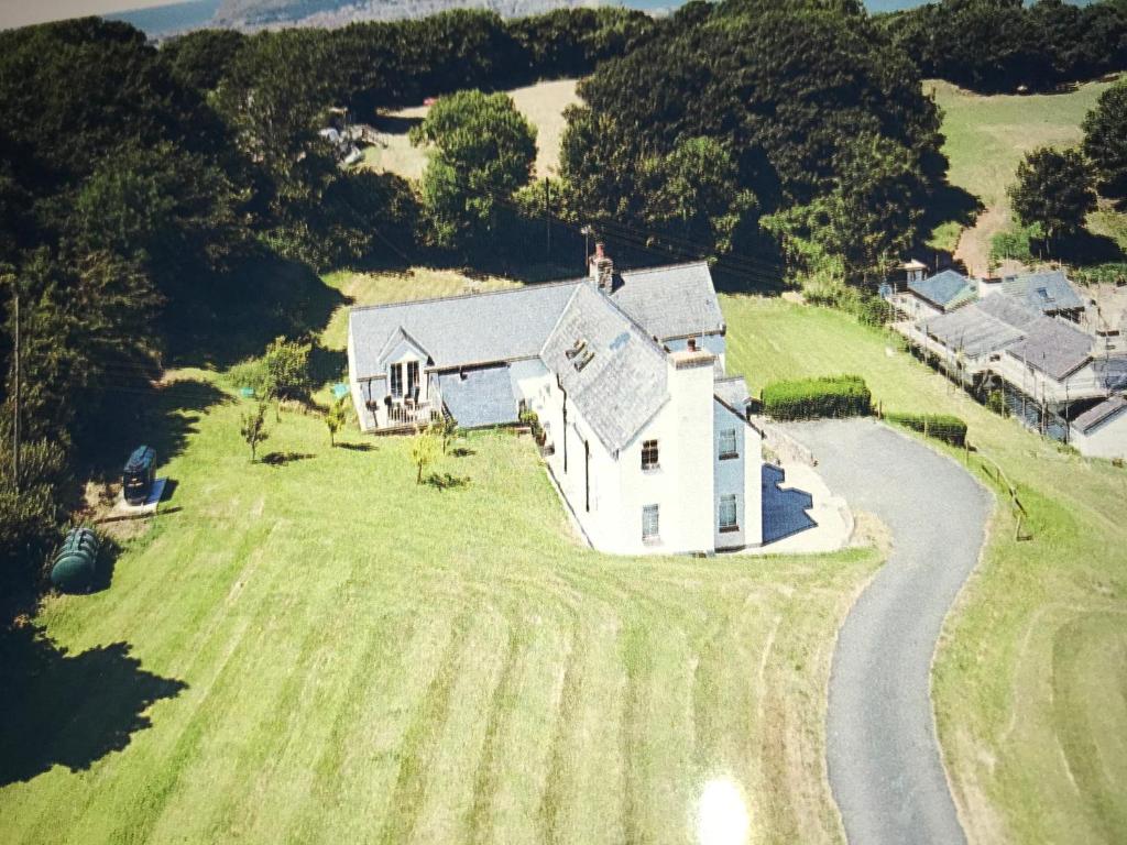 an aerial view of a white house on a grass field at Bryn Goleu Bed & Breakfast in Llandudno