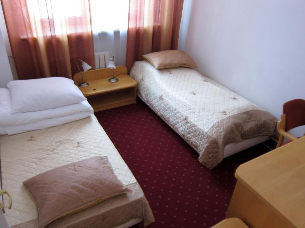 Posteľ alebo postele v izbe v ubytovaní Centrum Konferencyjne IBIB PAN