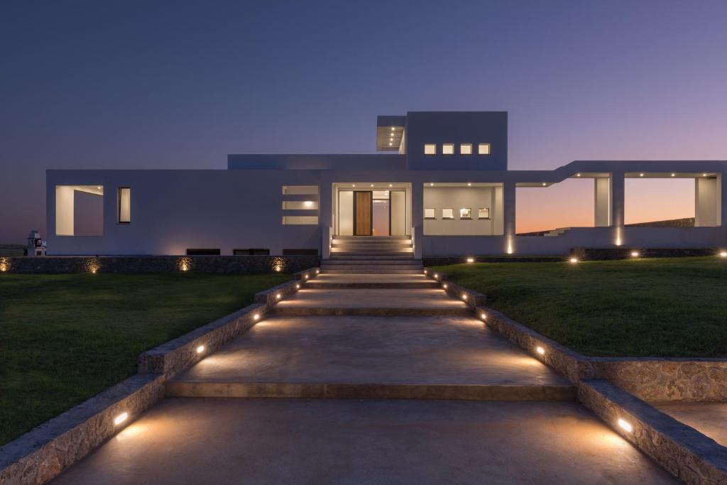 a house with a pathway leading to a yard with lights at Villa Afroditi, Corfu in Halikounas